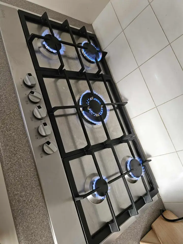 A gas cooktop with its burners lit